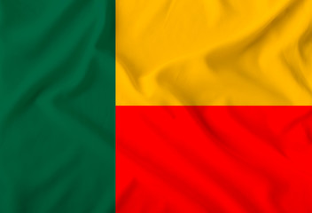 Fototapeta premium The color flag of the state of Benin, depicted on a silk fabric with soft folds