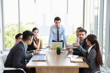caucasian businessman showing success business profit graph from white board in meeting with smile and happy face