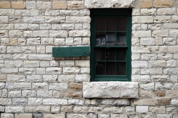 Closed window on the wall.