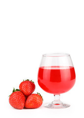 a glass of strawberry flavoured liquor with strawberries isolated and white background