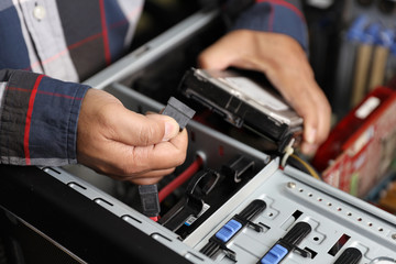Fototapeta na wymiar technician man fix or upgrading hard disk by unplug or plug cable on computer