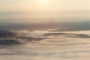 Fototapeta na wymiar Sunset.White mist.There are many mountains.