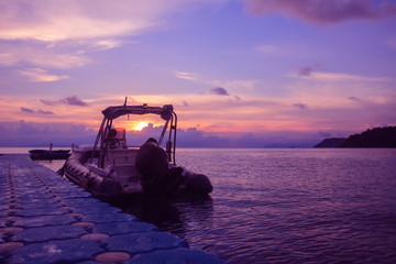 Obraz na płótnie Canvas Rubber boat or dinghy dock on the floating pier early morning beautiful sunrise