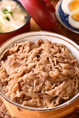 Gyudon - a bowl of rice with sliced beef, onion and sweet sauce. 