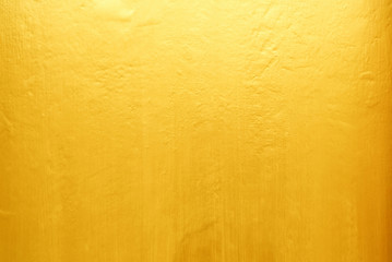Old Grunge Golden Painting on Wood Wall Background with Light Leak on Top.