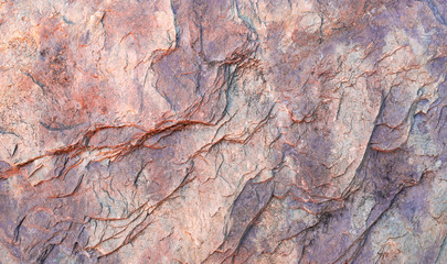 Stone texture background with unique pattern. Brown and gray dirty rock texture. Rock surface abstract background. Natural stone background. Rough stone wallpaper. Grunge and rust rock texture.