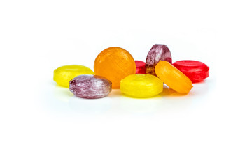 Medical lozenges for relief cough, sore throat and throat irritation isolated on white background. Cough and colds drop. Colorful cough pastille. Red, orange, yellow, and purple round candy or sweets.