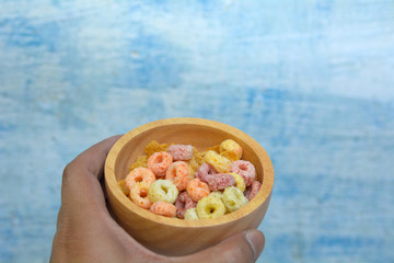 Hand on a cup of cereal for breakfast.