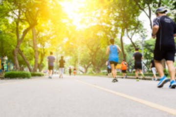 Blurred background of people running at park outdoor.