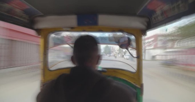 Tourist zooming in busy streets of Varanasi sitting inside auto rickshaw