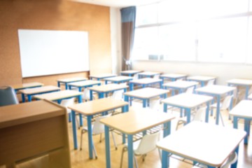 Classroom in blurred background without young student.