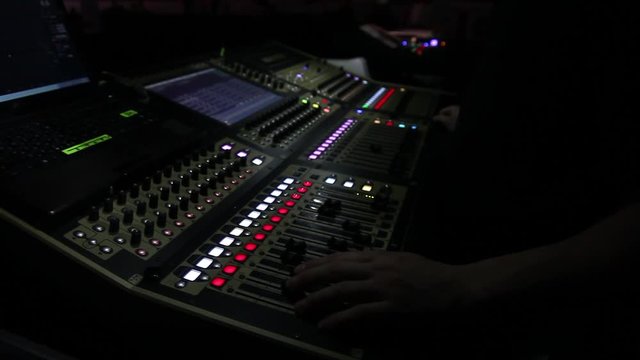remote recordists closeup. Hand adjusts sound effects. Electric machine on table for working of sound designer or club dj at party in nightclub. Occupation for modern lifestyle, objects for listen at 