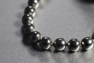 A steel chain in a grey background.