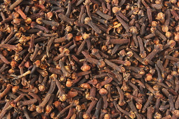 heap of dried spice clove aromatic flower buds as background
