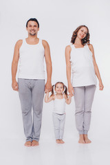 Cute baby learning to walk and make his first steps. mom is holding his hand. child's feet close up, copy space