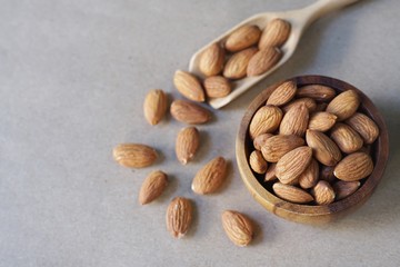Almond nut in wood bowl on wooden table background