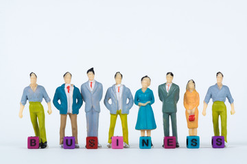 BUSINESS text and Group or figure miniature businessman of small people investor and office worker secretary on white background for money and financial business concept.