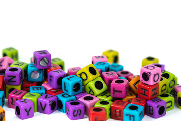 Naklejka premium Pile of letter bead or beads with alphabet on white background.