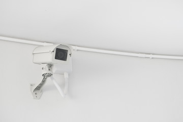 CCTV security camera installed on the building wall, operating indoor and outdoor, surveillance system.