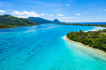 Aerial drone view of French Polynesia Tahiti island Huahine and Motu coral reef lagoon and Pacific Ocean. Tropical paradise.