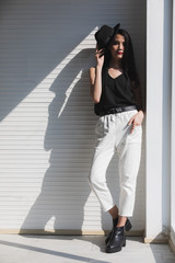 Asian woman clasp one's hands near window..