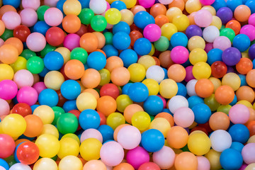 Fototapeta na wymiar Top view many colorful plastic gum balls in kid playroom at indoors playground.