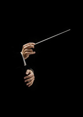 Hands of conductor on a black background - obrazy, fototapety, plakaty