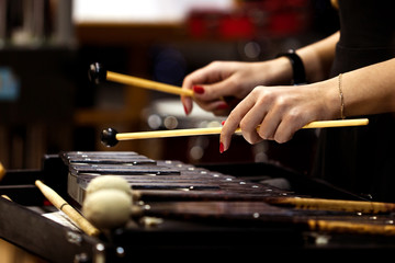 Hands of a girl playing the glockenspiel