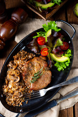 Pork steak with mushrooms and buckwheat groats and mango salad