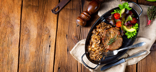 Pork steak with mushrooms and buckwheat groats and mango salad