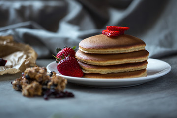 Photo of trendy asian food fluffy pancake, Japan pancake, souffle pancake with syrup and strawberry for menu, web or app using.