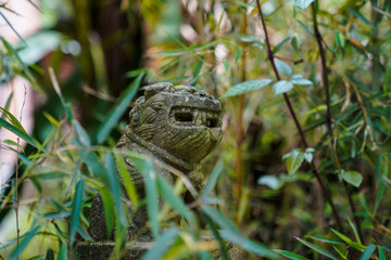 Lion clay sculptures hidden in green plants