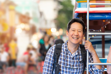 Tourist sightseeing old town ,traveling concept. Asian man with smiling face  standing beside pho...