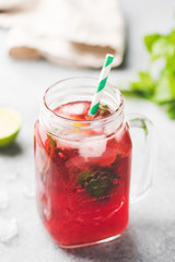 Berry Ice Tea In Glass Cup With Drinking Straw. Selective Focus, Vertical Orientation