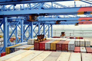 Gantry cranes are loading containers on the container ship.