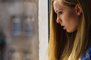 Shocked teenage woman looking through