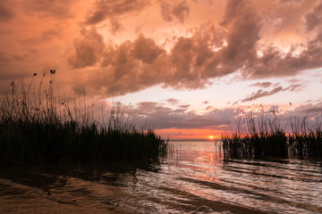 Sunset, sunrise landscape on a lake.Beautiful nature.Blue Sky, amazing colorful clouds.Natural Background, sun.