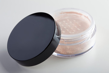 jar of face powder. Professional cosmetics. Loose powder. Tools make-up artist. Natural beige color.