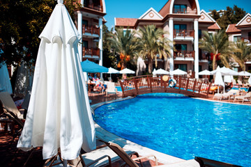 View on big blue swimming pool in front of hotel.