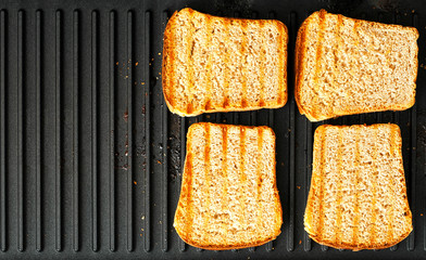 4 toasted slices of grilled bread until golden crust. Ready bread for food. Ready-made slices of bread for making a sandwich. Copy space. 