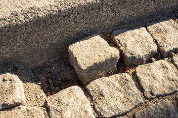 Broken square stone paving on top
