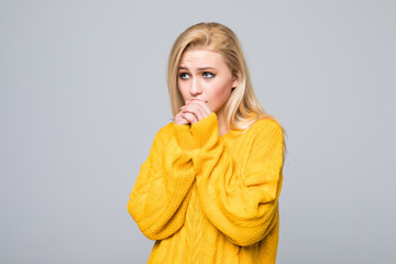 Young Woman freezingwith yellow sweater over isolated on gray background