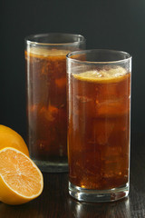Glasses with cuba libre cocktail or cola with ice or cold tea with lemon