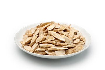 Sliced ​​of Astragalus (Huang Qi) in a ceramic dish, isolated on white background. Chinese...