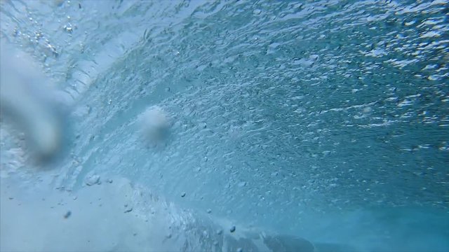 Ocean wave barrels and breaks over the camera