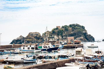 Fototapeta na wymiar Acitrezza harbor with fisher boats next to Cyclops islands, Catania, Sicily, Italy.