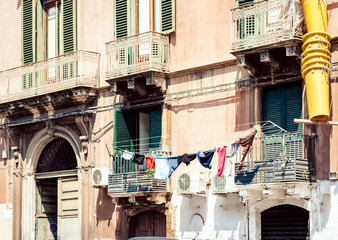 Traditional architecture of Sicily in Italy, typical street of Catania, facade of old buildings .