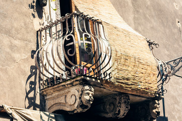 balcony in old baroque building in Catania, traditional architecture of Sicily, Italy.