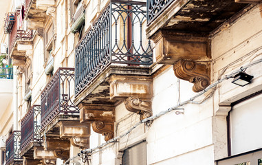 balcony in old baroque building in Catania, traditional architecture of Sicily, Italy.