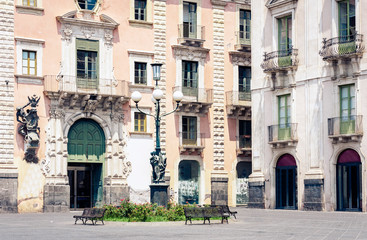 Fototapeta na wymiar Traditional architecture of Sicily in Italy, typical street of Catania, facade of old buildings .